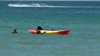 President Marcelo Rebelo de Sousa helps two women in the water