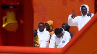 Migrants on board the tug boat
