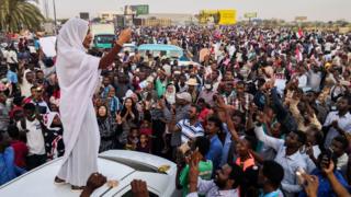 Alaa Salah, a woman propelled to internet fame after clips went viral of her leading powerful protest chants against President Omar al-Bashir, addresses protesters during a demonstration in front of the military headquarters in the capital Khartoum, Sudan - Wednesday 10 April 2019