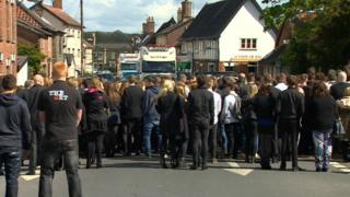 Crowds gathered in front of lorry convoy
