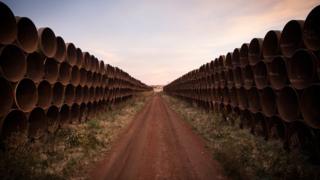 Miles of unused pipe, prepared for the proposed Keystone XL pipeline, sit in a lot on October 14, 2014 outside Gascoyne, North Dakota.