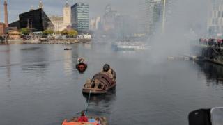 boy giant in boat pulled through dock by boat