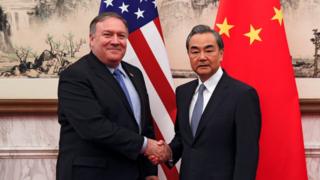 U.S. Secretary of State Mike Pompeo shakes hands with Chinese Foreign Minister Wang Yi as they pose for a photograph at the Diaoyutai State Guesthouse in Beijing