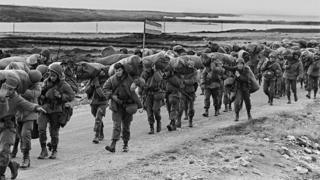 Argentine soldiers (troops) walking on their way to occupy the captured Royal Marines base in Puerto Argentino/Port Stanley