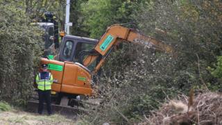 Police with digging equipment at the site where a human torso was found during a dig for the remains of convicted rapist James Nolan who vanished more than six years ago, at Tolka Valley Park, Finglas, Dublin
