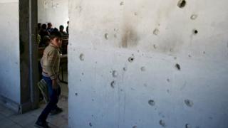 Student at damaged school in the rebel-held Douma neighbourhood of Damascus, Syria 30 March 2016