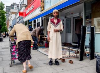 A young worshipper arrives for Friday prayer at the Holloway Mosque in London.