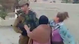 Screengrab of a video showing a Palestinian girl appear to strike an Israeli soldier in the West Bank village of Nabi Salih on 15 December 2017
