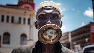 A man wearing what looks like a metal-disc as a mask in Kampala, Uganda - Wednesday 1 April 2020