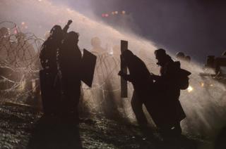 Police use a water cannon on protesters during a protest against plans to pass the Dakota Access pipeline near the Standing Rock
