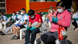 A woman waiting to be tested for the coronavirus in Lima, Peru.