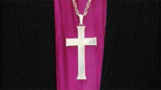 A cross worn on a chain