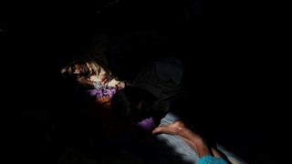 Rohingya refugee Almor Yhan, 59, rests with relatives hours after crossing the Bangladesh-Myanmar border near Cox's Bazar, Bangladesh