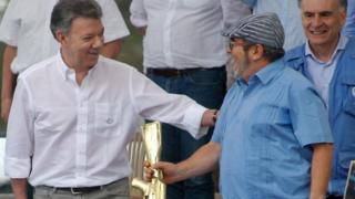 FARC rebel leader Timochenko and Colombian President Juan Manuel Santos in the disarmament ceremony