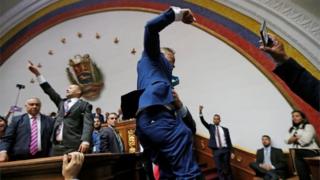 Opposition lawmakers enter the building of Venezuela's National Assembly in Caracas on 5 January, 2020.