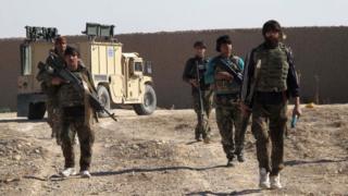 Afghan National Army (ANA) soldiers walk in Helmand on December 21, 2015
