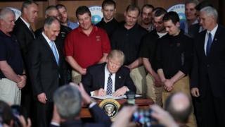 Trump assina decreto acompanhado de mineiros
