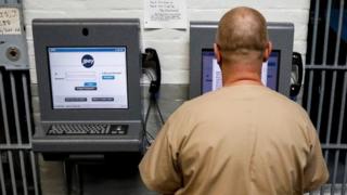 An inmate in New Jersey demonstrates JPay, an online network used by prisoners