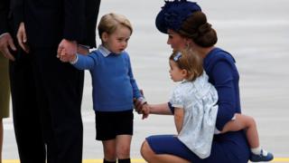 Catherine, Duchess of Cambridge, holds the hand of her son Prince George while carrying Princess Charlotte as they arrive at the Victoria International Airport for the start of their eight day royal tour to Canada in Victoria, British Columbia, Canada,