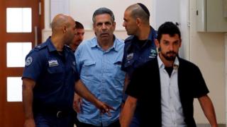 File photo showing Gonen Segev being led into court in Jerusalem on 5 July 2018