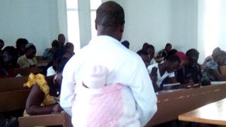 Man carrying baby on his back