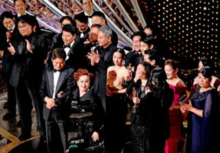 The cast and crew of Parasite accept their Oscar for best picture