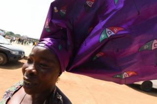 A woman wears a headdress decorated with the logo of the Nigeria's opposition party Peoples Democratic Party (PDP) as she arrives for the presidential party candidate Atiku Abubakar"s campaign rally in Ilorin, Nigeria - Wednesday 5 December 2018