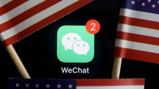 The messenger app WeChat is seen among U.S. flags in this illustration picture taken Aug. 7, 2020