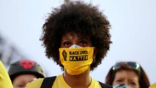 Protester in Portland with a face covering that says "Black Lives Matter" on it