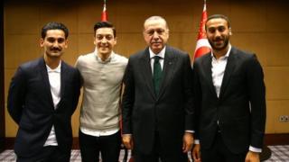 lkay Gundogan and Mesut Ozil, along with Everton's Cenk Tosun, pose with the Turkish president