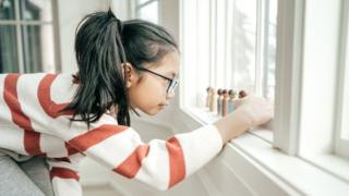 Anak perempuan bermain dengan mainan kayu