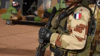 A French soldier of the detachment of the Operation Barkhane stands guard on January 2, 2015 at a French base outside the northern Malian city of Gao