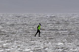 A jogger running by water