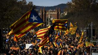 Pro Independence demonstrators wave "esteladas" or pro independence flags, during a demonstrations to show public support for the Parliament of Catalonia, in Barcelona