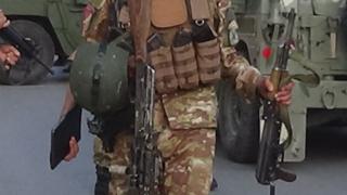 An Afghan soldier holds a gun