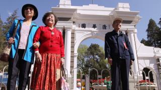 Alumni take photos in Tsinghua University in Beijing on April 24, 2011. Tsinghua University celebrates its centenary anniversary today. 24APR11 Photo by Simon Song