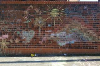Chalk drawings over 'vile' graffiti