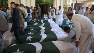 Скорбящие собираются вокруг гробов жертв нападения на полицейскую академию в Кветте