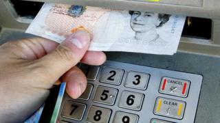 Money being taken out of a cashpoint