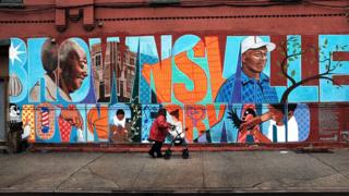 A painted sign reads "Brownsville. Moving Forward"