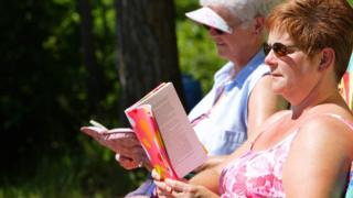 Women relaxing and reading a book