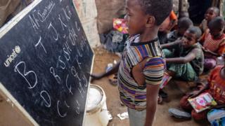 A displaced Somali boy attends a class at a makeshift school at the Badbado IDP camp in Mogadishu, Somalia - 25 June 2018