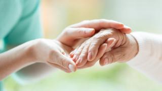   Nurse and patient holding hands 