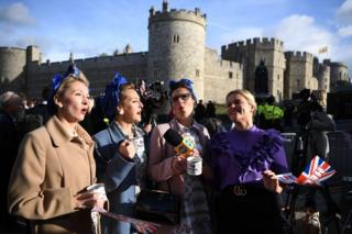 Royal supporters get into position outside of Windsor Castle ahead of the Royal wedding