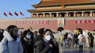 People wear masks in Beijing, China