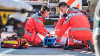 Paramedics treating a patient