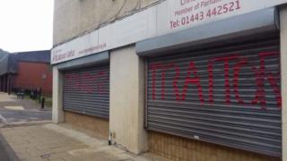 Shutters on Chris Bryant's offices with graffiti reading 'Traitor'