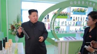 Kim Jong Un holds a hairspray can