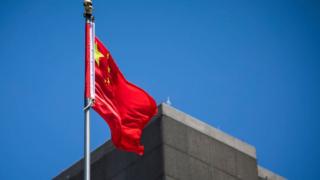 The flag of the People's Republic of China flies in the wind above the Consulate General of the People's Republic of China in San Francisco