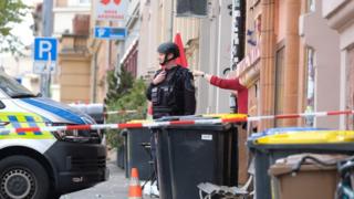 Policemen secure the area around the site of a shooting in Halle